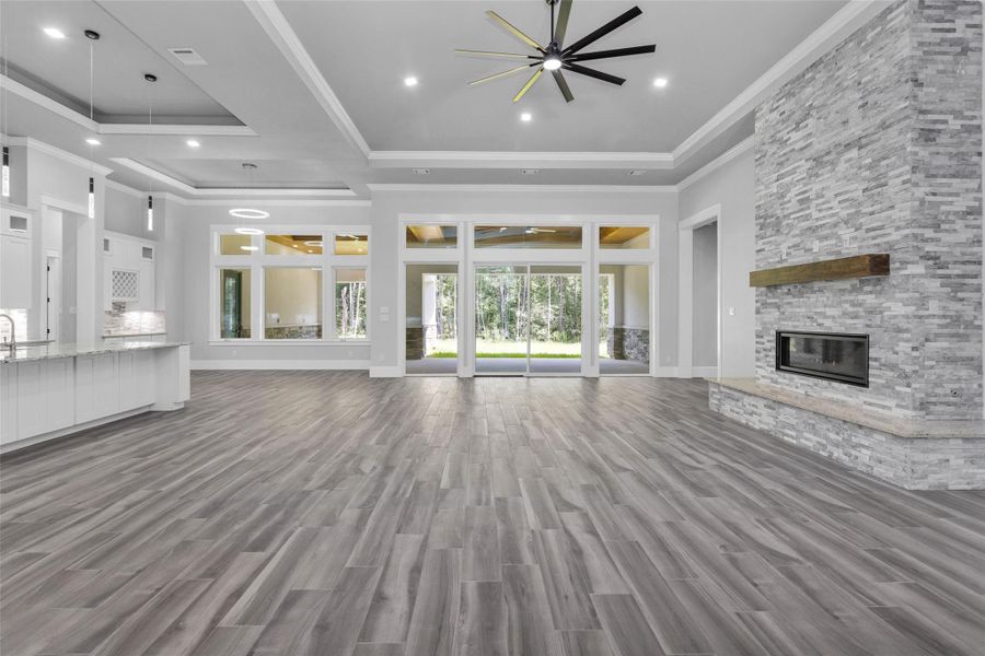 Kitchen, Dining Room & Family Room feature architectural tray ceilings and are bathed in natural light from the abundant glass doors, windows, transoms, inset lighting and chandeliers.