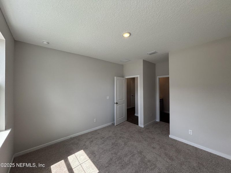Spacious, unfurnished interior of a new home in The Cypress Series at Reserve East, Flagler Beach (Image 26).