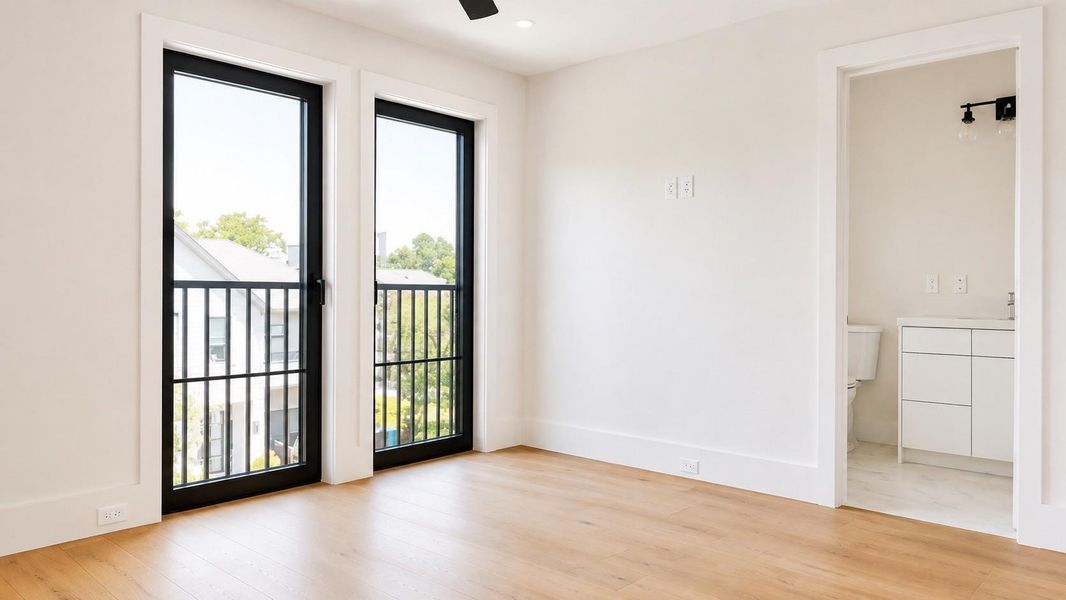 Third floor flex room with wood flooring, floor to ceiling windows, and an en suite bath,