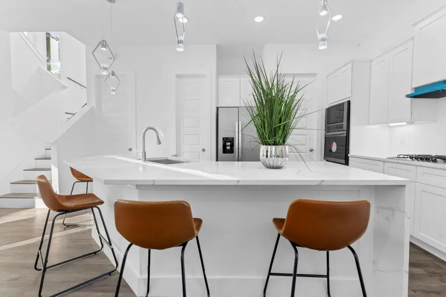 Spacious island with waterfall edges, perfect for cooking and gathering.