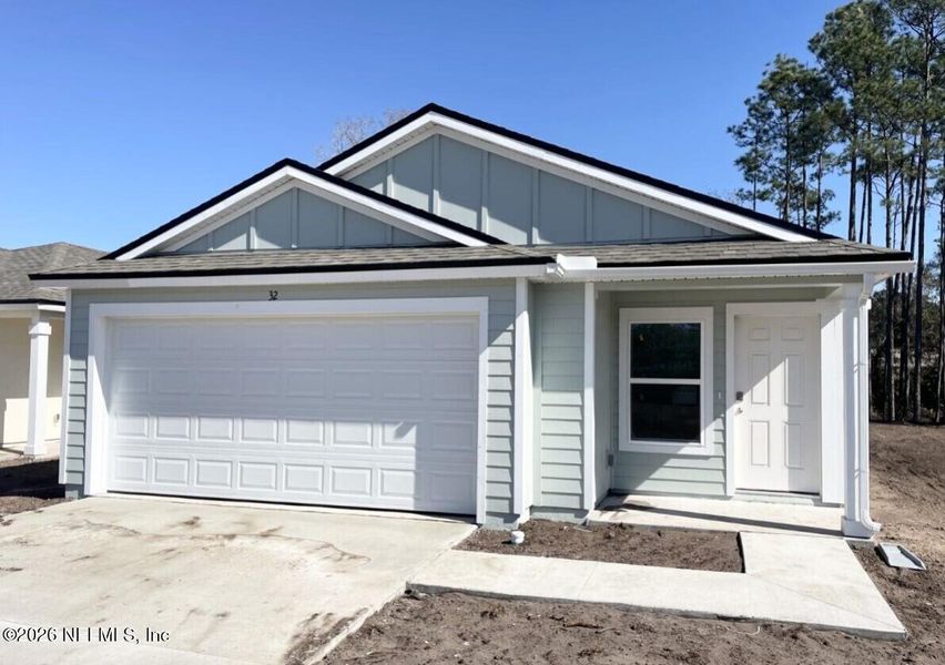 Front exterior of a new home in Grand Reserve, Bunnell, FL, highlighting curb appeal (Image 2).