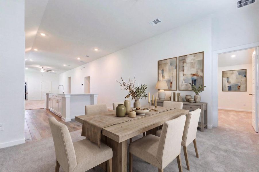 The open-concept layout continues with a bright living area that flows directly into the kitchen and main gathering spaces. Soft carpet, tall ceilings, recessed lighting, and clean white walls create a spacious and flexible setting, while the nearby room access adds convenience for everyday living. This photo has been virtually staged for visual reference. The open-concept layout continues with a bright living area that flows directly into the kitchen and main gathering spaces. Soft carpet, tall ceilings, recessed lighting, and clean white walls create a spacious and flexible setting, while the nearby room access adds convenience for everyday living. This photo has been virtually staged for visual reference.