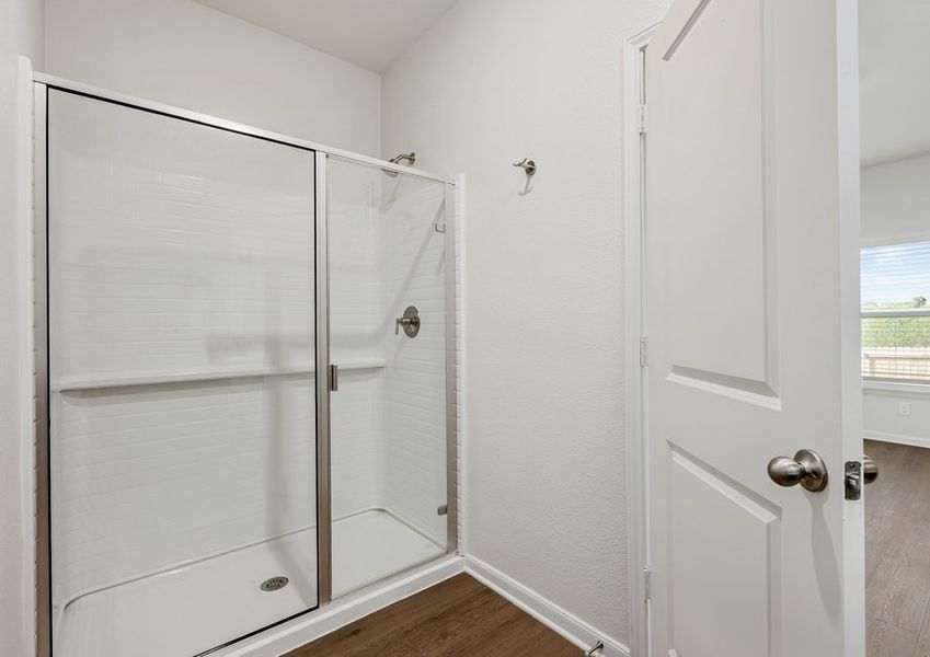 The master bathroom has a glass, walk-in shower.