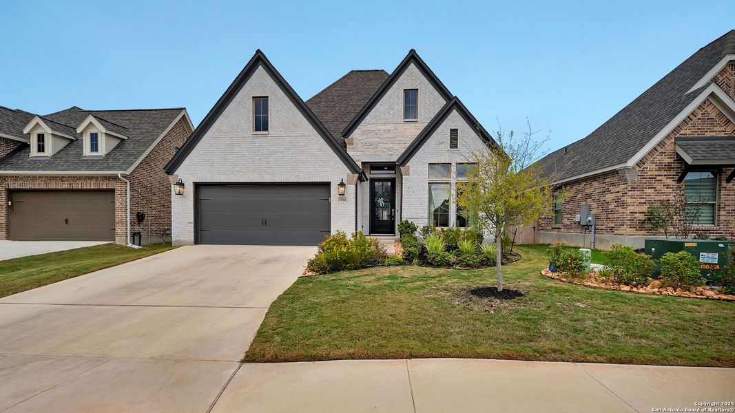 Front exterior of a new home in Meadows Of Mill Creek 50', Seguin, TX, highlighting curb appeal (Image 1). Front exterior of a new home in Meadows Of Mill Creek 50', Seguin, TX, highlighting curb appeal (Image 1).