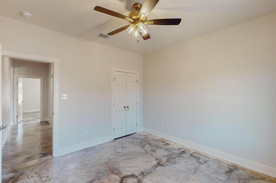 Unfurnished bedroom with a closet and ceiling fan