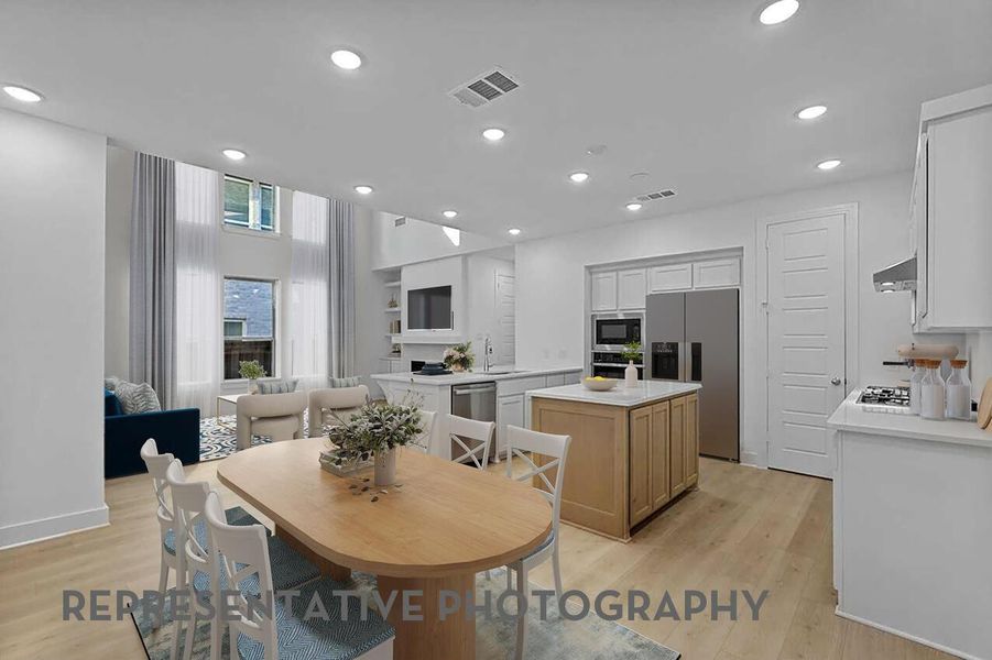 A welcoming kitchen with a cozy breakfast nook off to the side creates the perfect spot for casual meals and gathering together.
