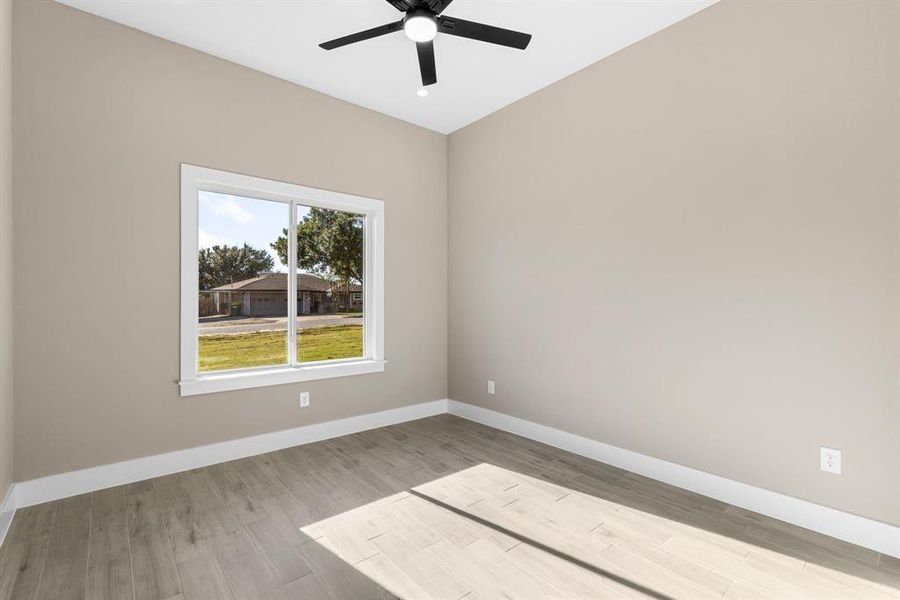 Unfurnished room featuring ceiling fan and light hardwood / wood-style flooring