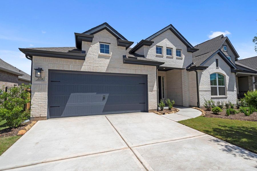 Front exterior of a new home in Jordan Ranch, Fulshear, TX, highlighting curb appeal (Image 2).