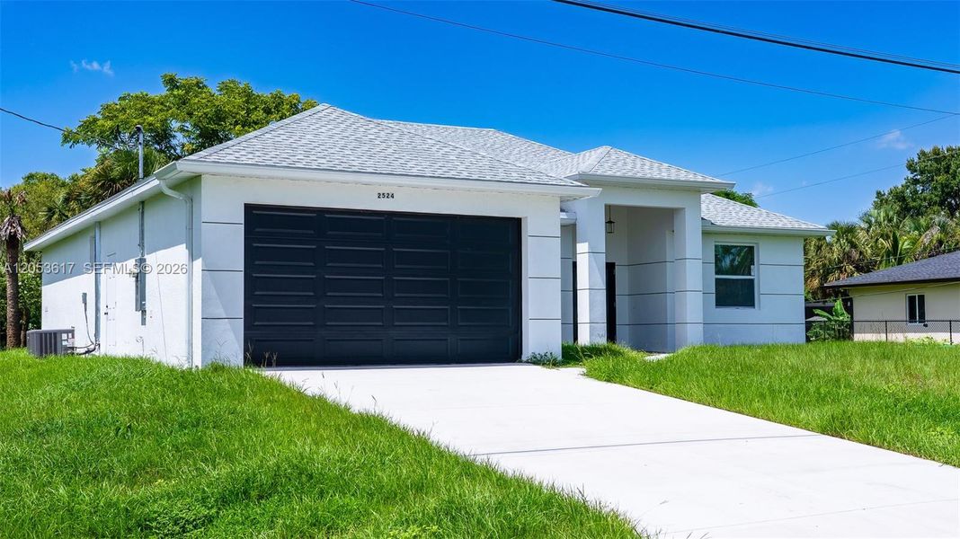 Front exterior of a new home in , Lehigh Acres, FL, highlighting curb appeal (Image 11).