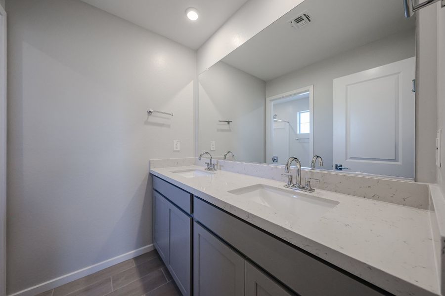 A bathroom with a large mirror. A bathroom with a large mirror.