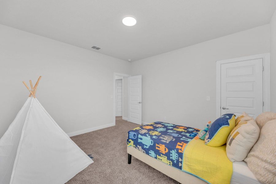 Carpeted bedroom with baseboards