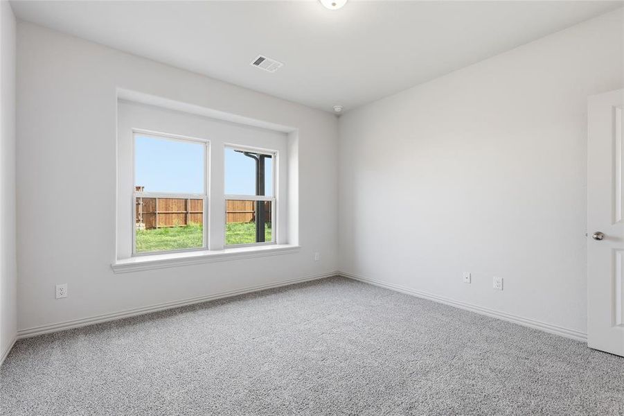 Neutral white walls paired with light gray carpet flooring