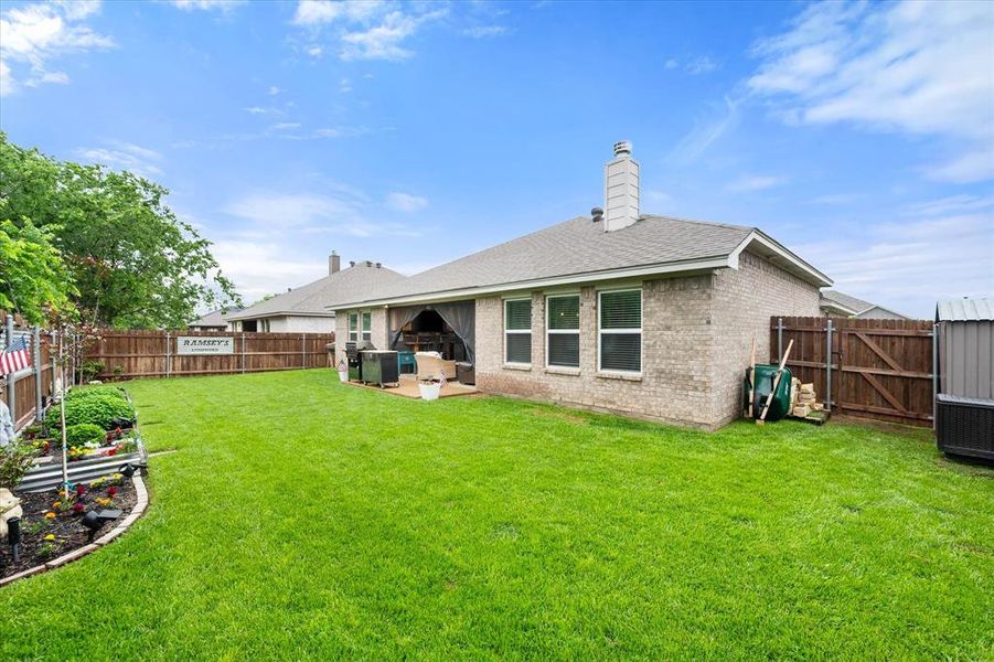Fully landscaped with raised beds for gardening