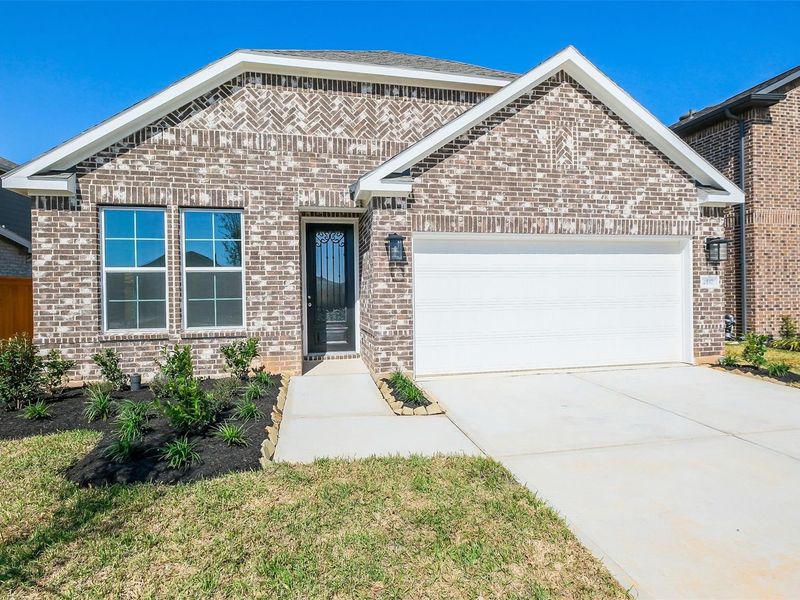 Front exterior of a new home in Sunterra, Katy, TX, highlighting curb appeal (Image 24).