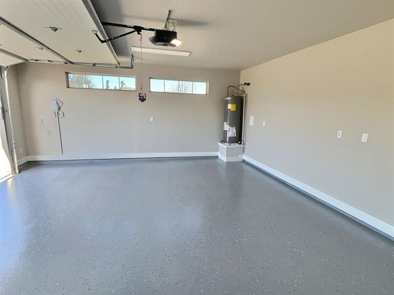 Garage with electric water heater and a garage door opener