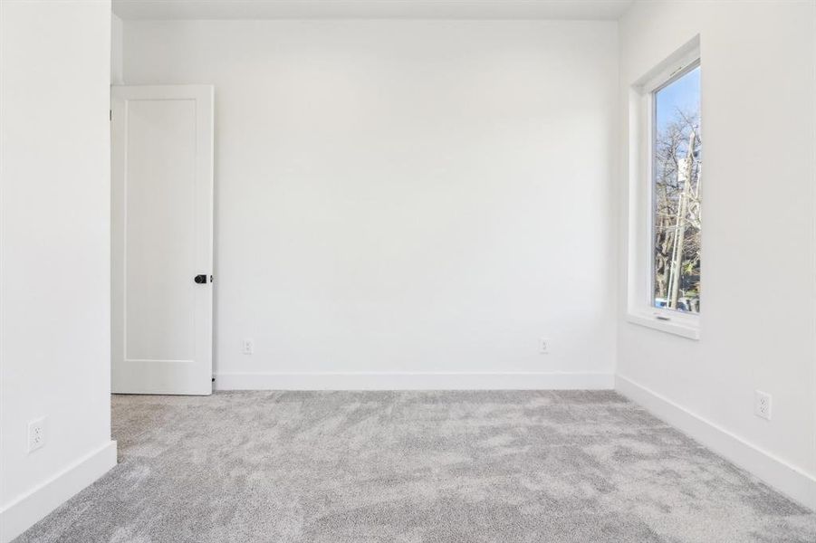 Unfurnished room featuring light colored carpet