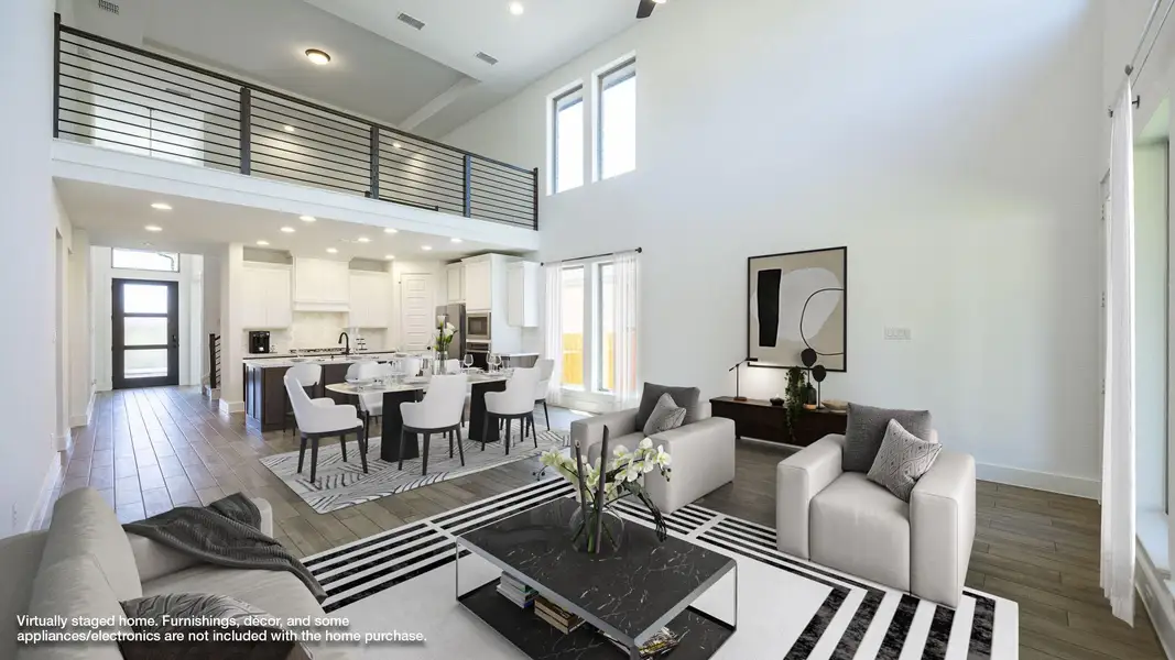 Living area featuring recessed lighting, a high ceiling, visible vents, baseboards, and wood finished floors Living area featuring recessed lighting, a high ceiling, visible vents, baseboards, and wood finished floors