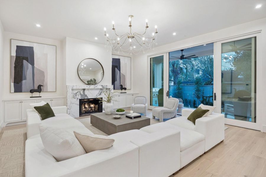 An open-concept gathering space designed to seamlessly connect indoor living with the outdoors, featuring expansive Pella sliding doors and a layout ideal for both everyday living and entertaining. An open-concept gathering space designed to seamlessly connect indoor living with the outdoors, featuring expansive Pella sliding doors and a layout ideal for both everyday living and entertaining.