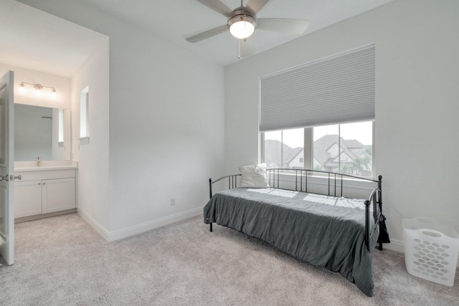 This secondary bedroom has direct access to its own vanity within a Jack-and-Jill bath