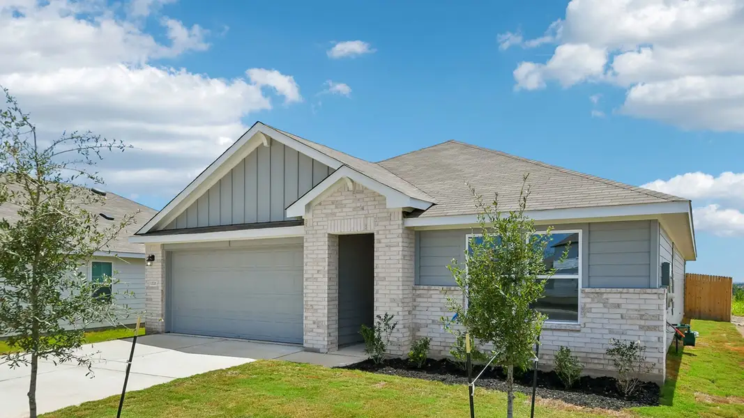 Front exterior of a new home in Carillon, Manor, TX, highlighting curb appeal (Image 18).