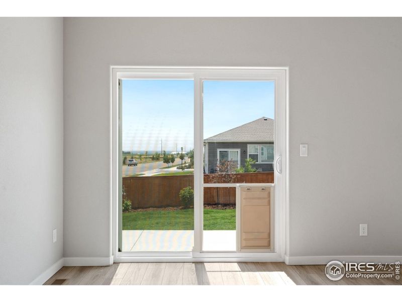 Patio door off eat-in kitchen; professional installation of replacement slider door with dog door panel