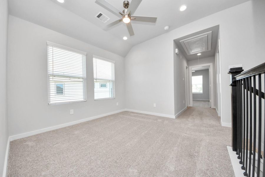 Discover a haven of leisure in this fantastic game room! Whether you're seeking a casual hangout or an adult gaming retreat, this space has it all. Enjoy the luxurious feel of plush carpet underfoot, the expansive ambiance of high ceilings, custom paint that adds a touch of personality, and windows that flood the room with refreshing natural light. Sample photo of completed home with similar floor plan. Actual colors and selections may vary. Discover a haven of leisure in this fantastic game room! Whether you're seeking a casual hangout or an adult gaming retreat, this space has it all. Enjoy the luxurious feel of plush carpet underfoot, the expansive ambiance of high ceilings, custom paint that adds a touch of personality, and windows that flood the room with refreshing natural light. Sample photo of completed home with similar floor plan. Actual colors and selections may vary.