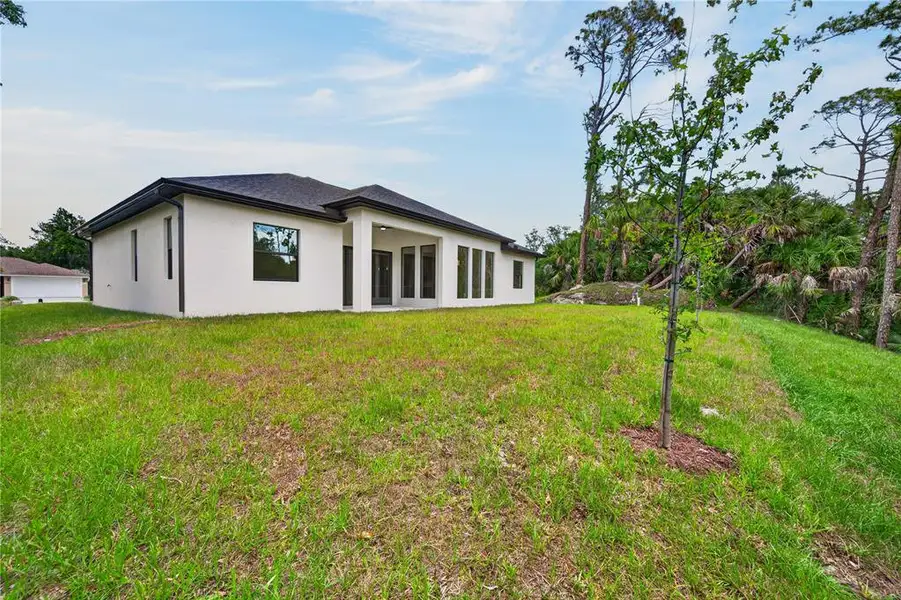 Exterior details and patio area of a home in , North Port (Image 39).
