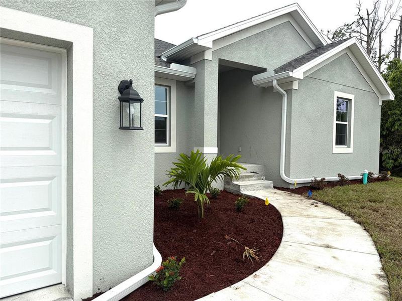 Front exterior of a new home in South Gulf Cove, Port Charlotte, FL, highlighting curb appeal (Image 13). Front exterior of a new home in South Gulf Cove, Port Charlotte, FL, highlighting curb appeal (Image 13).