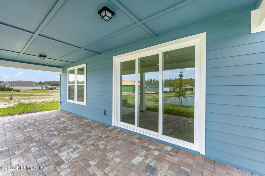 Exterior details and patio area of a home in Del Webb Wildlight, Wildlight (Image 28).