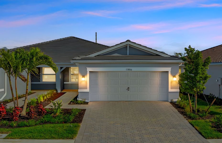 Front exterior of a new home in Legacy Groves, Nokomis, FL, highlighting curb appeal (Image 1). Front exterior of a new home in Legacy Groves, Nokomis, FL, highlighting curb appeal (Image 1).