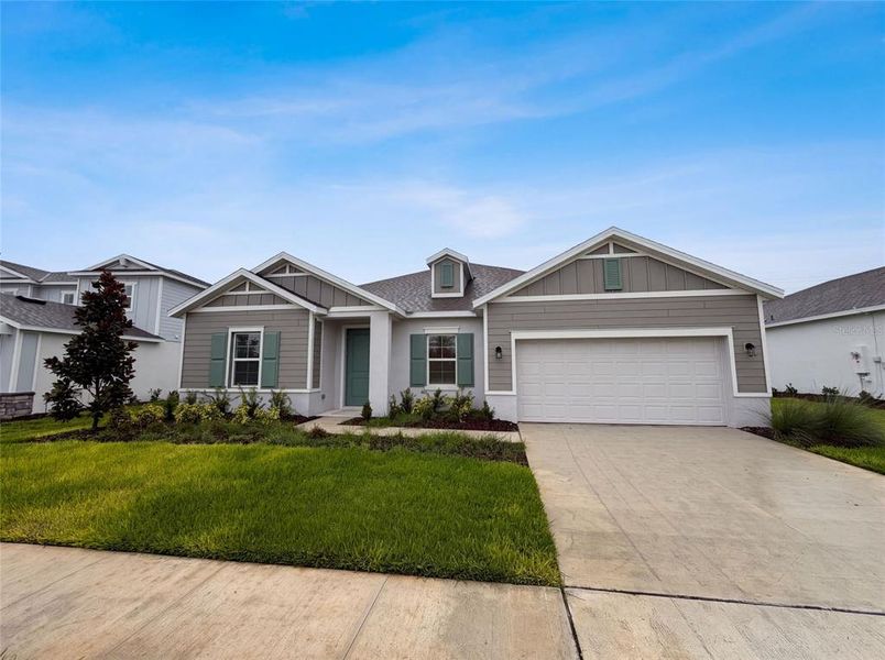 Front exterior of a new home in Meadow Pointe, Groveland, FL, highlighting curb appeal (Image 2).
