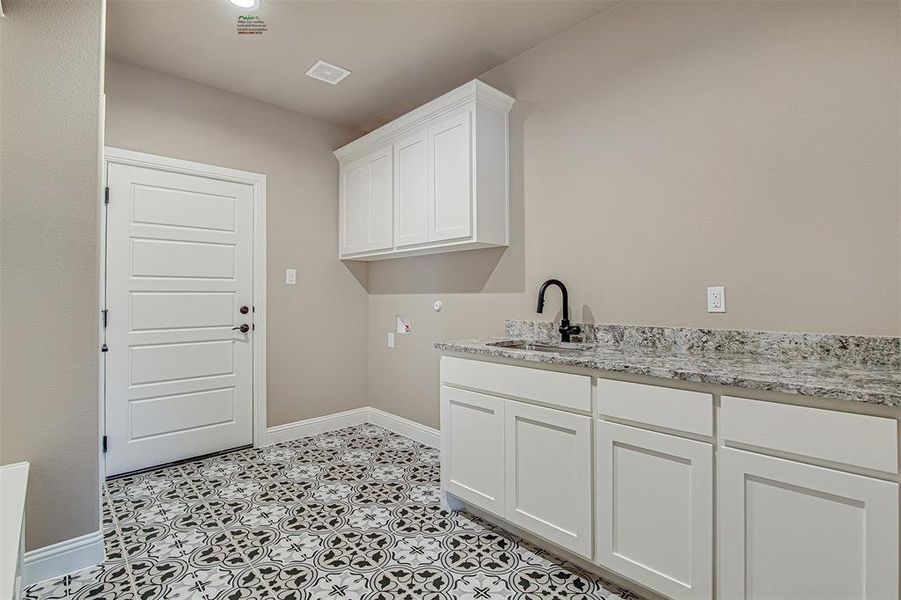 Laundry room with washer hookup, cabinets, and sink