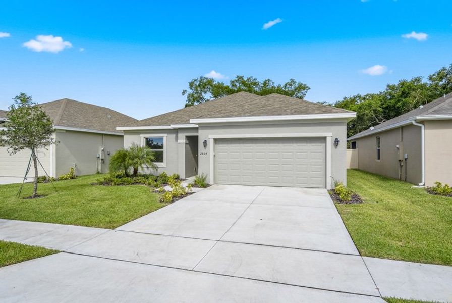 Front exterior of a new home in Eden Hills, Lake Alfred, FL, highlighting curb appeal (Image 27).