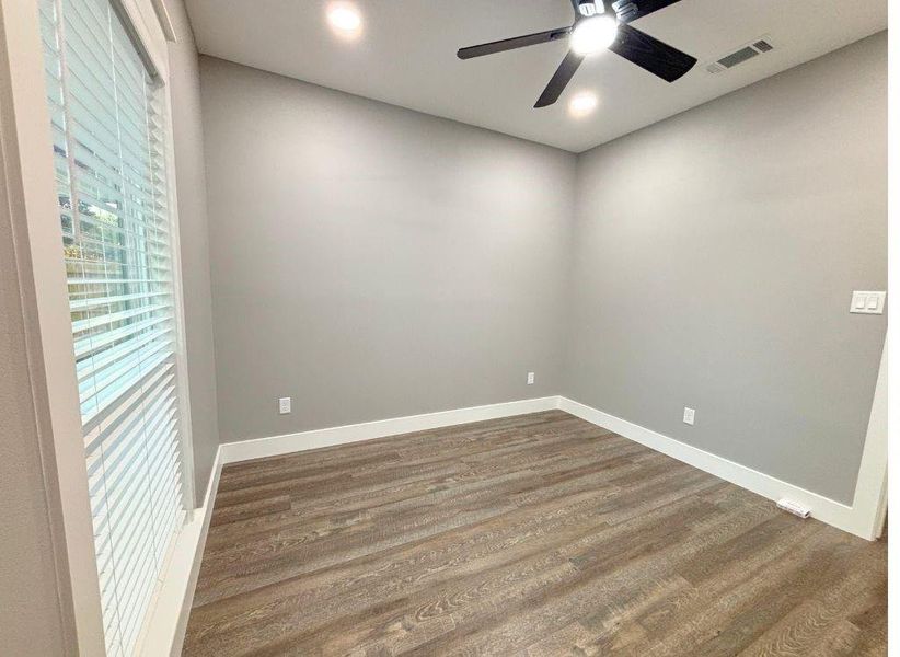 Spare room featuring wood finished floors, a ceiling fan, and recessed lighting Spare room featuring wood finished floors, a ceiling fan, and recessed lighting