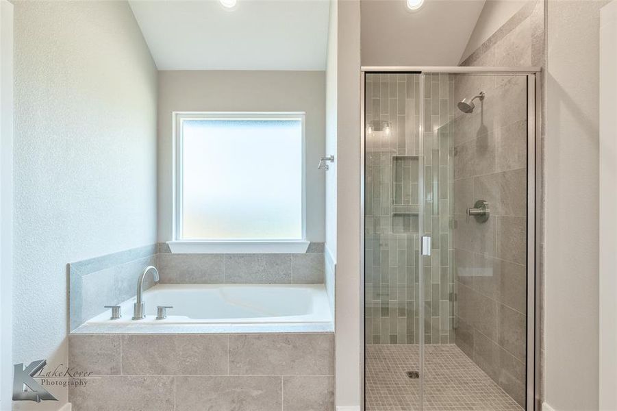 Bathroom with a bath and a shower stall