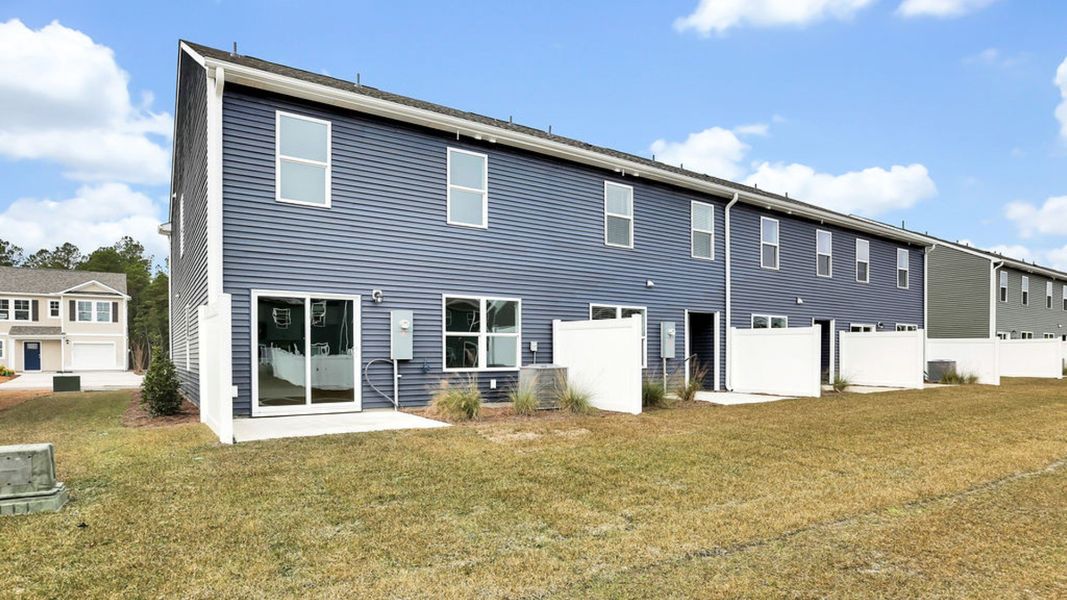 Exterior details and patio area of a home in Grayson Park Townhomes, Leland (Image 3).