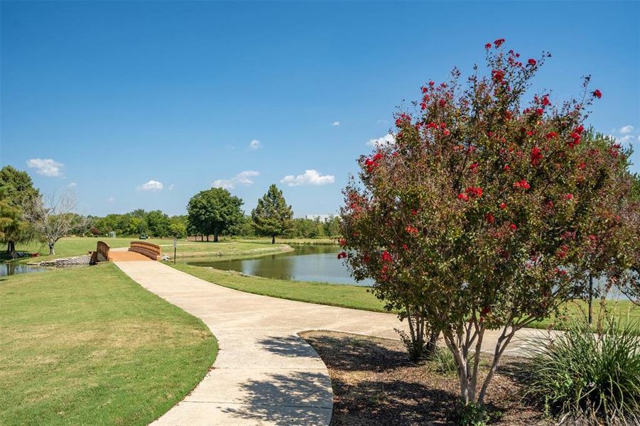 Surrounding community featuring a water view and a lawn Surrounding community featuring a water view and a lawn