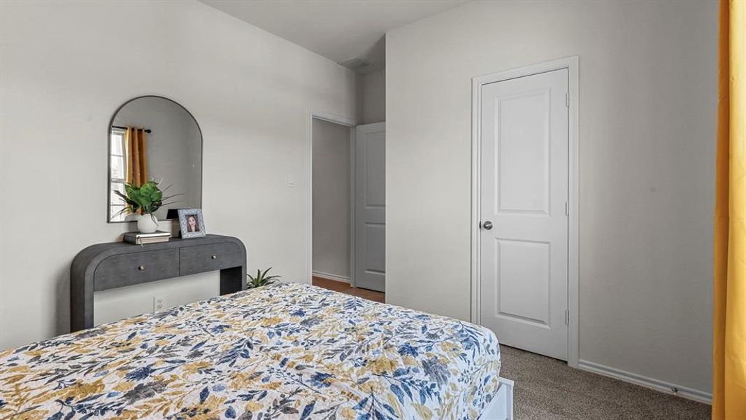 Carpeted bedroom with baseboards