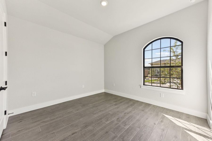 Empty room featuring vaulted ceiling, recessed lighting, and light wood-style floors Empty room featuring vaulted ceiling, recessed lighting, and light wood-style floors