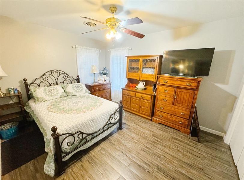 Bedroom with light wood-style flooring and ceiling fan