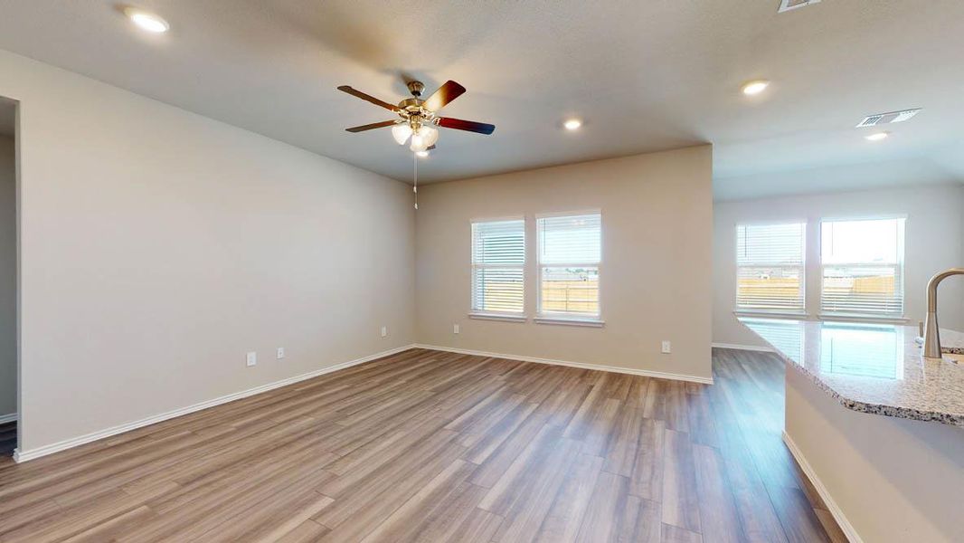 Unfurnished living room featuring dark wood-type flooring, recessed lighting, and ceiling fan