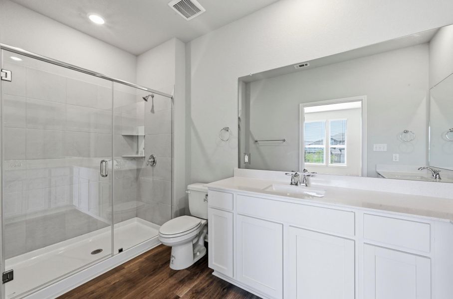 Modern bathroom featuring a double vanity with white cabinetry and integrated sinks Modern bathroom featuring a double vanity with white cabinetry and integrated sinks