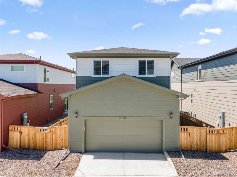 Front exterior of a new home in Woodrose at Painted Prairie, Aurora, CO, highlighting curb appeal (Image 27). Front exterior of a new home in Woodrose at Painted Prairie, Aurora, CO, highlighting curb appeal (Image 27).