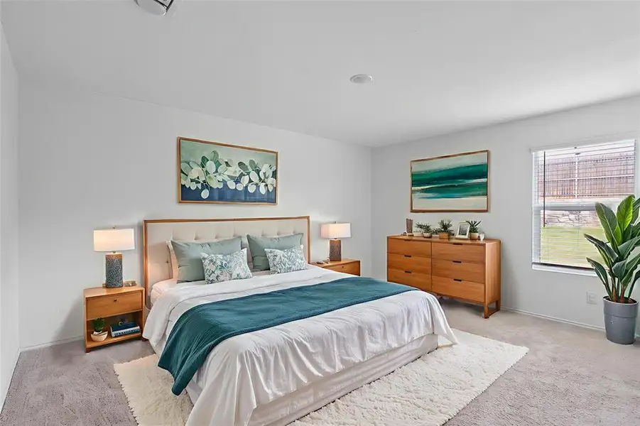 Bedroom featuring carpet floors and baseboards