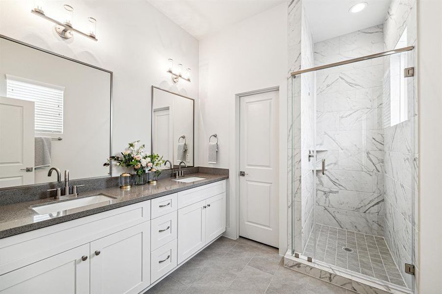 The primary bath features a largewalk-in shower with durable andsleek tile extending to the ceiling.