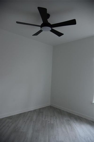 Unfurnished room featuring ceiling fan and light hardwood / wood-style flooring