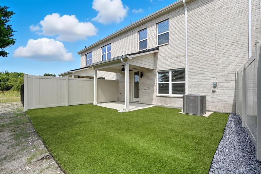 Back of house featuring a patio, a fenced backyard, brick siding, and ceiling fan Back of house featuring a patio, a fenced backyard, brick siding, and ceiling fan