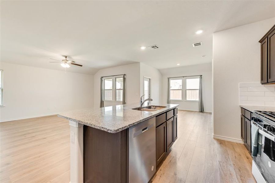 Back of property featuring a patio, a shingled roof, and a fenced backyard Back of property featuring a patio, a shingled roof, and a fenced backyard