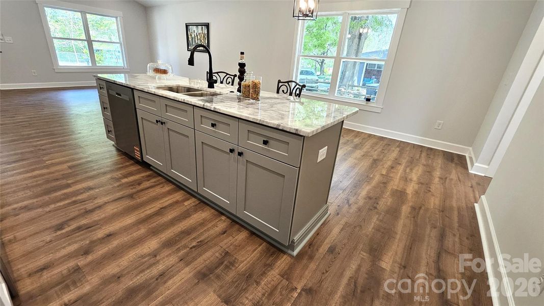 Huge island with marble counters has storage.