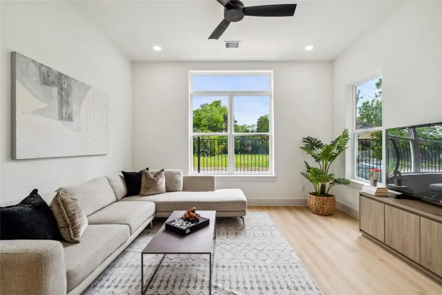 Enjoy natural serenity through oversized windows that frame green space views and flood the living room with soft, all-day light. Enjoy natural serenity through oversized windows that frame green space views and flood the living room with soft, all-day light.